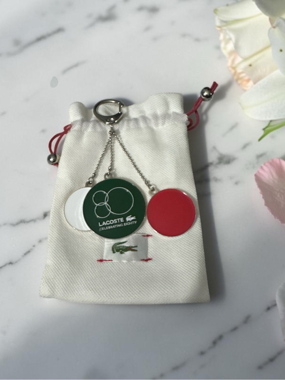 Lacoste Red, Green & White Round Token Keychain W/Dust bag NWOT